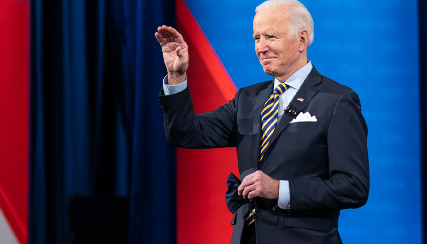 Joe Biden waving on a stage