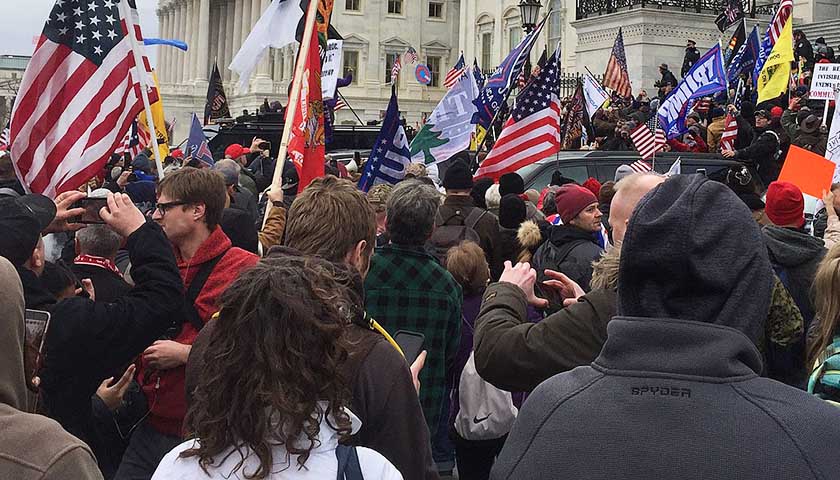 Large group of people storming Washington D.C. in protest on January 6.